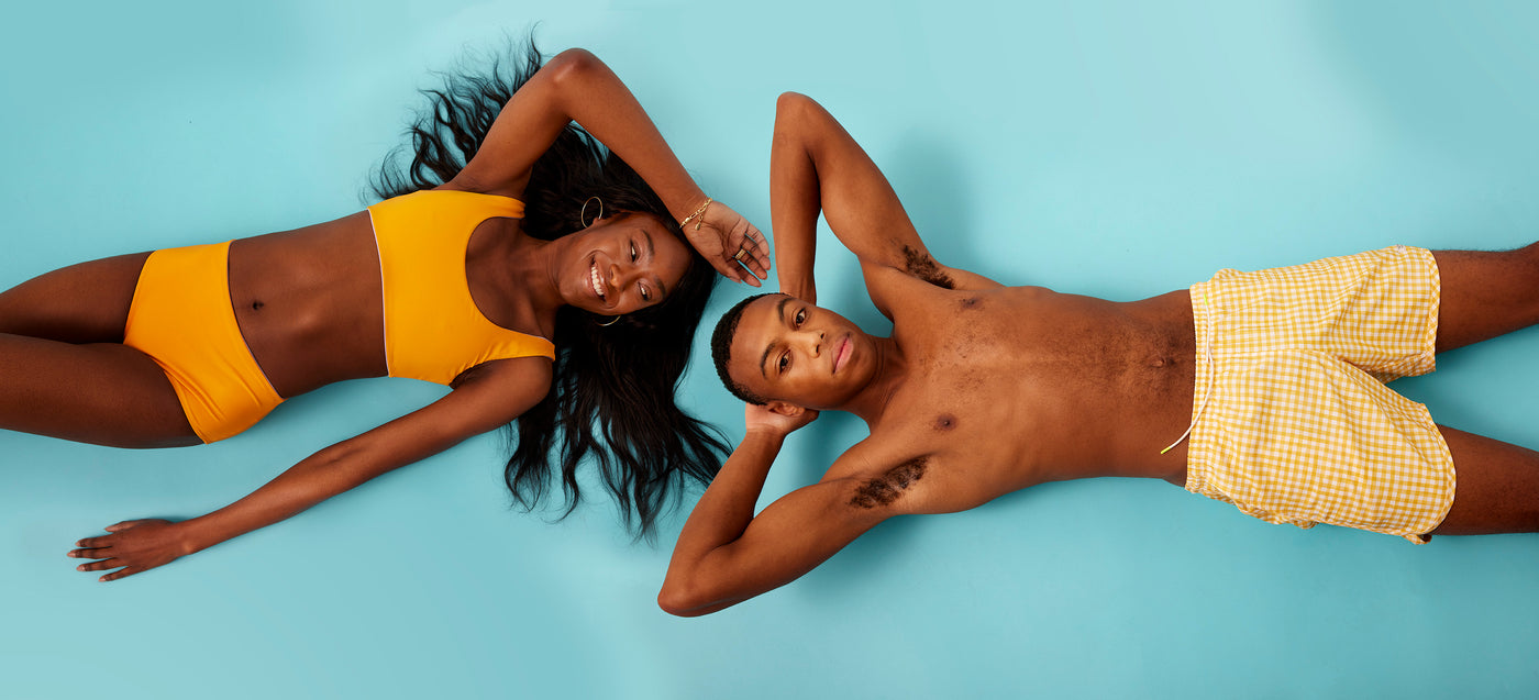Women's tangerine reversible sport bikini and men's gingham swim trunks
